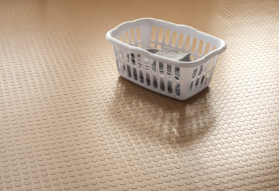 sandstone tan large coin vinyl flooing with white laundry basket