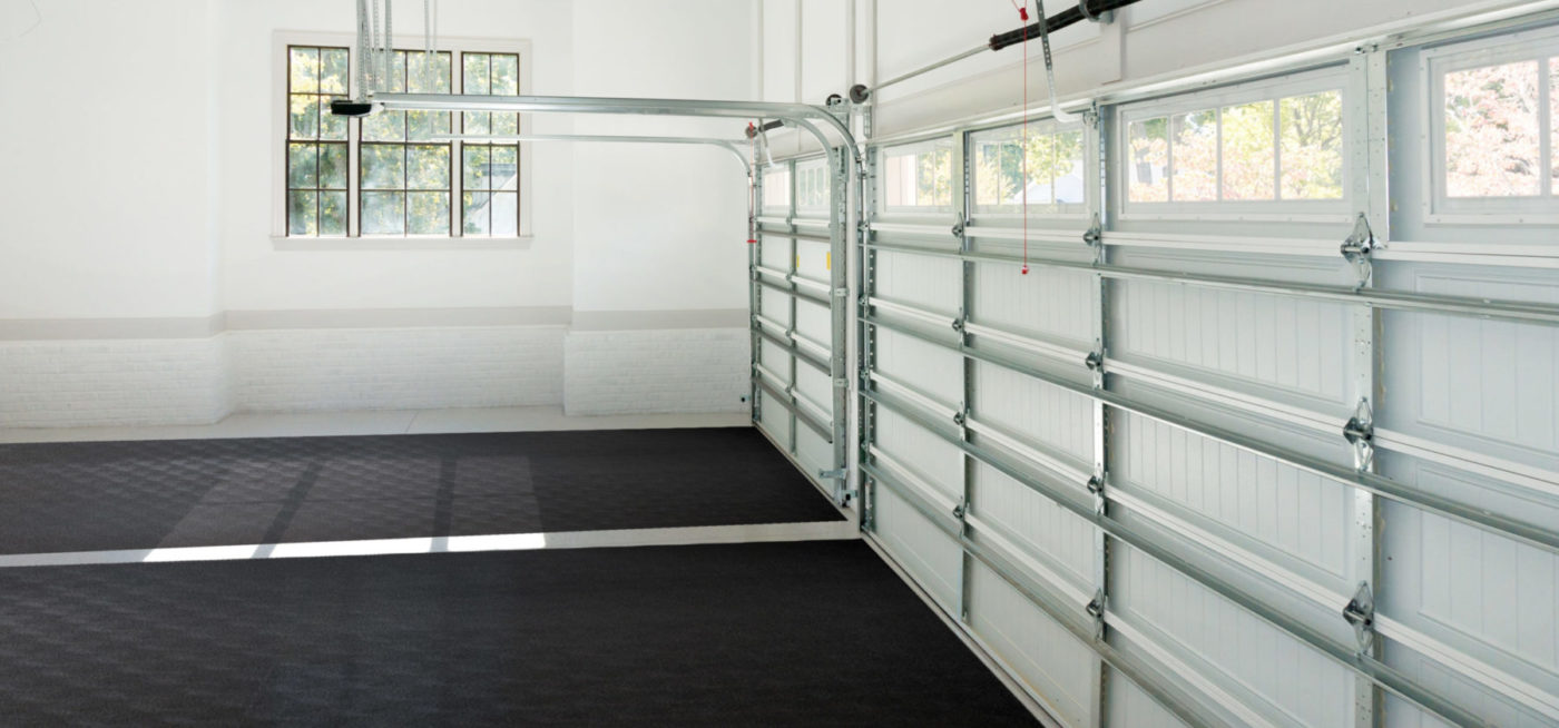 two black garage mats in large garage