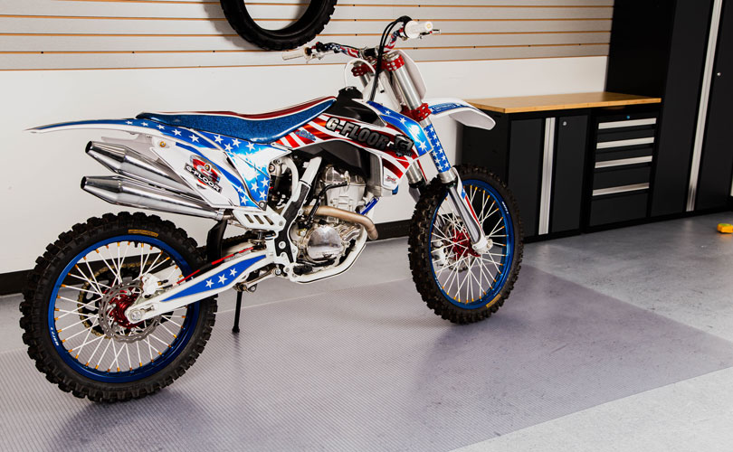 USA red, white, and blue motorcycle on clear floor protector