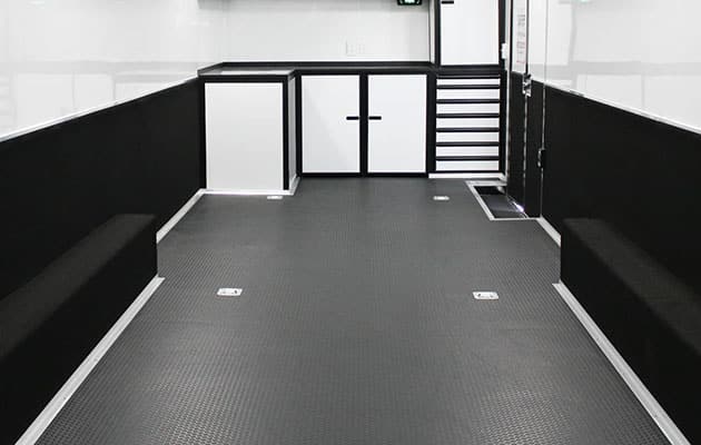 grey small coin flooring in white trailer