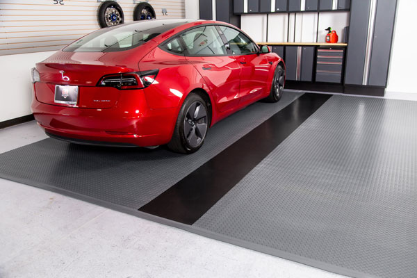 Red Tesla in garage with G-Floor flooring and runner