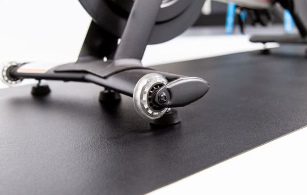 exercise bike on top of black equipment mat